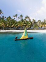 A traditional Guna sailing cayuco off the beach