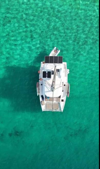 Top-down aerial of the Leopard 40 catamaran resting on bright turquoise shallows
